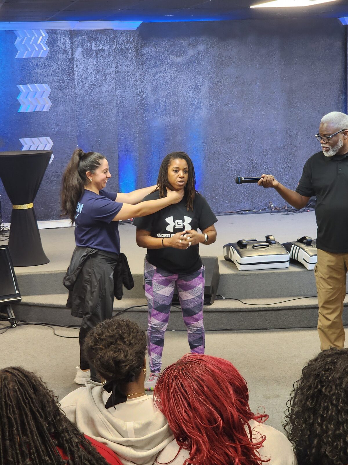 Casilda teaching self-defense techniques during a community training session